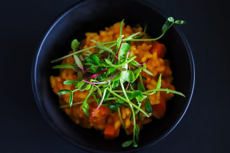 Carrot Risotto with Pea and Chard Microgreens is a fun riff on the classic peas and carrots. Carrot juice reduces and enriches this delicate and delicious risotto recipe. Easy to make and fun to eat!